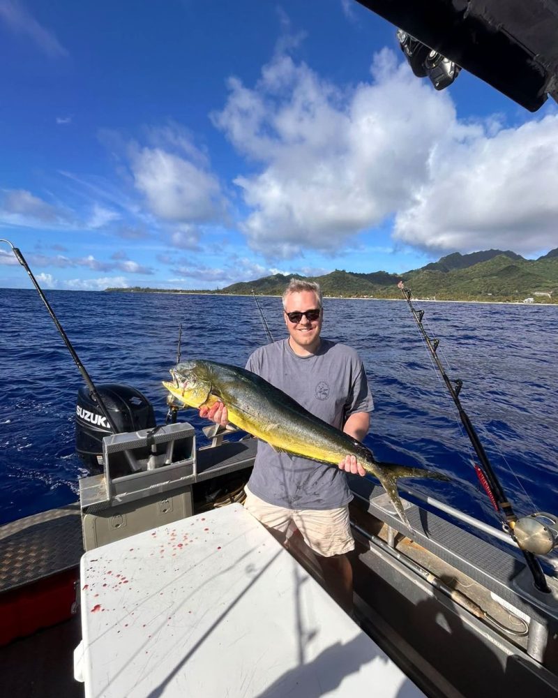 An angler with a mahi-mahi on deck