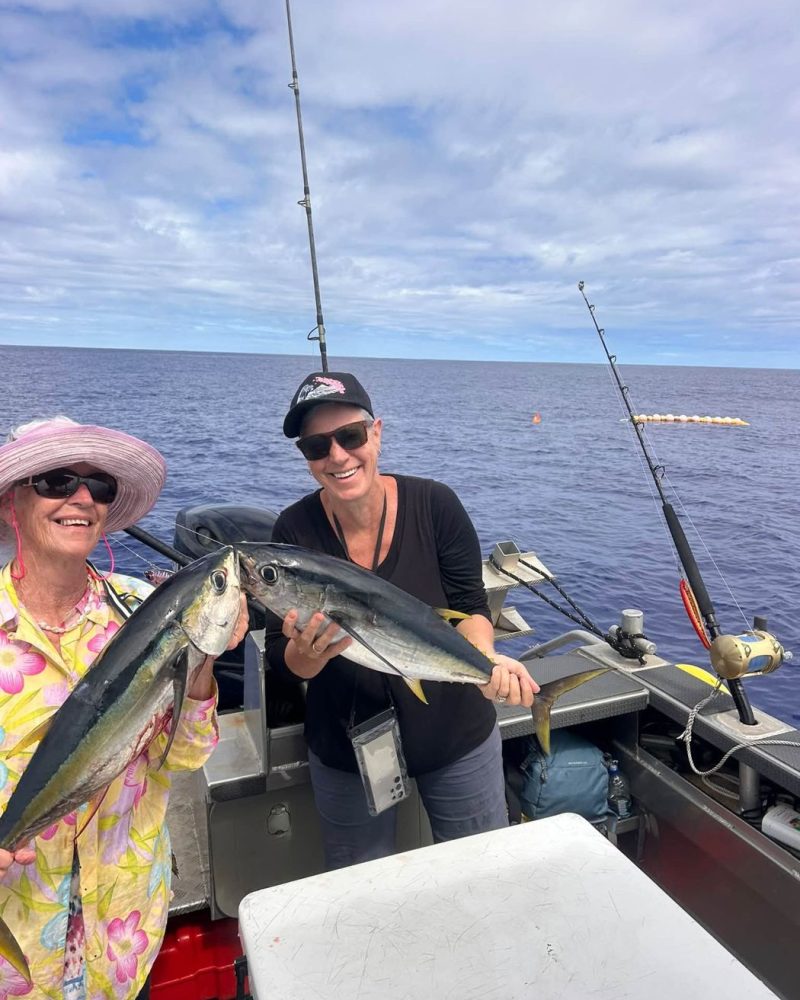 Two happy anglers with yellowfin tuna